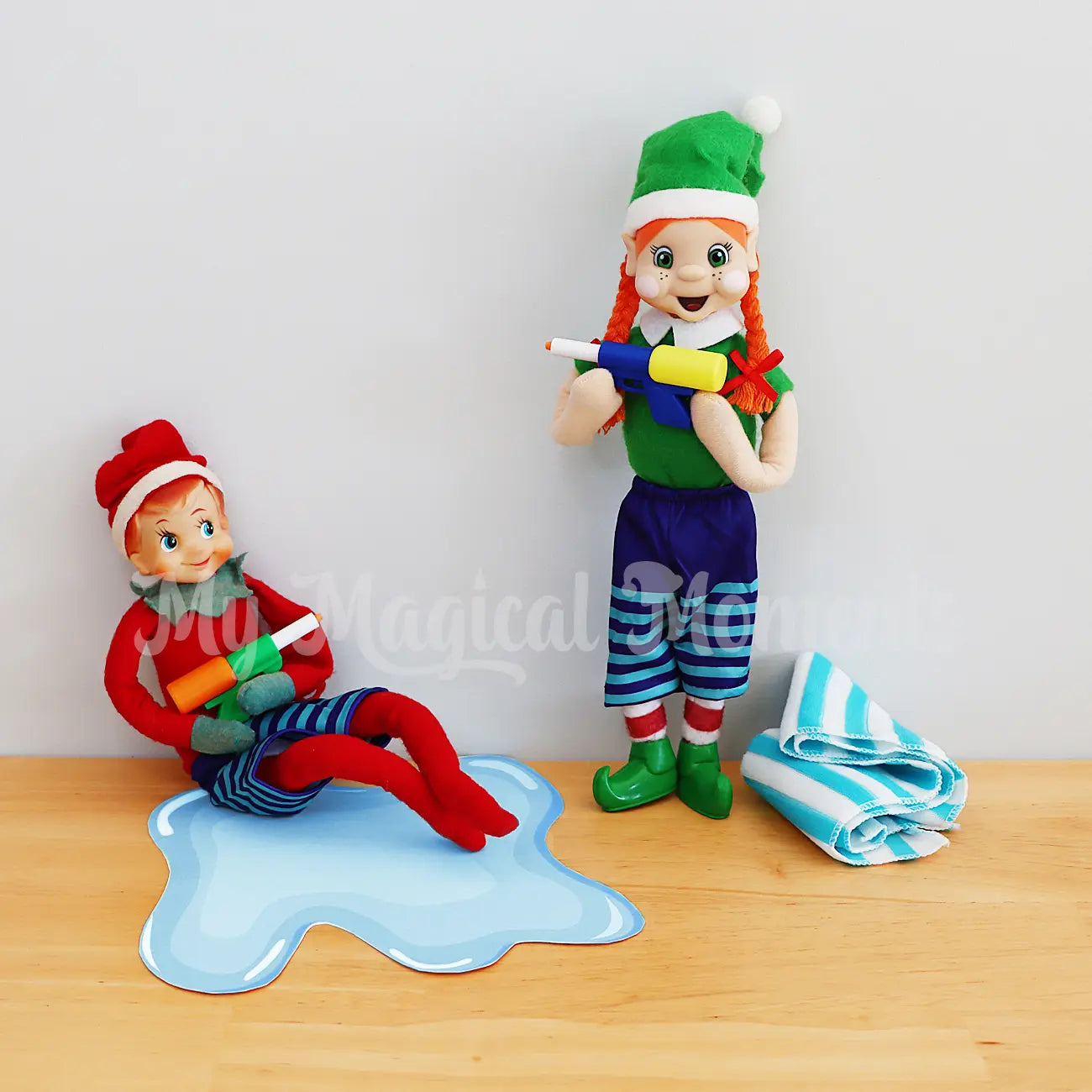 Elves having a water gun fight with mini water pistols and towel in boardshorts