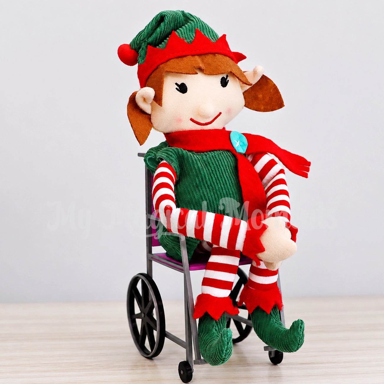 elf for christmas in a pink wheelchair in the home