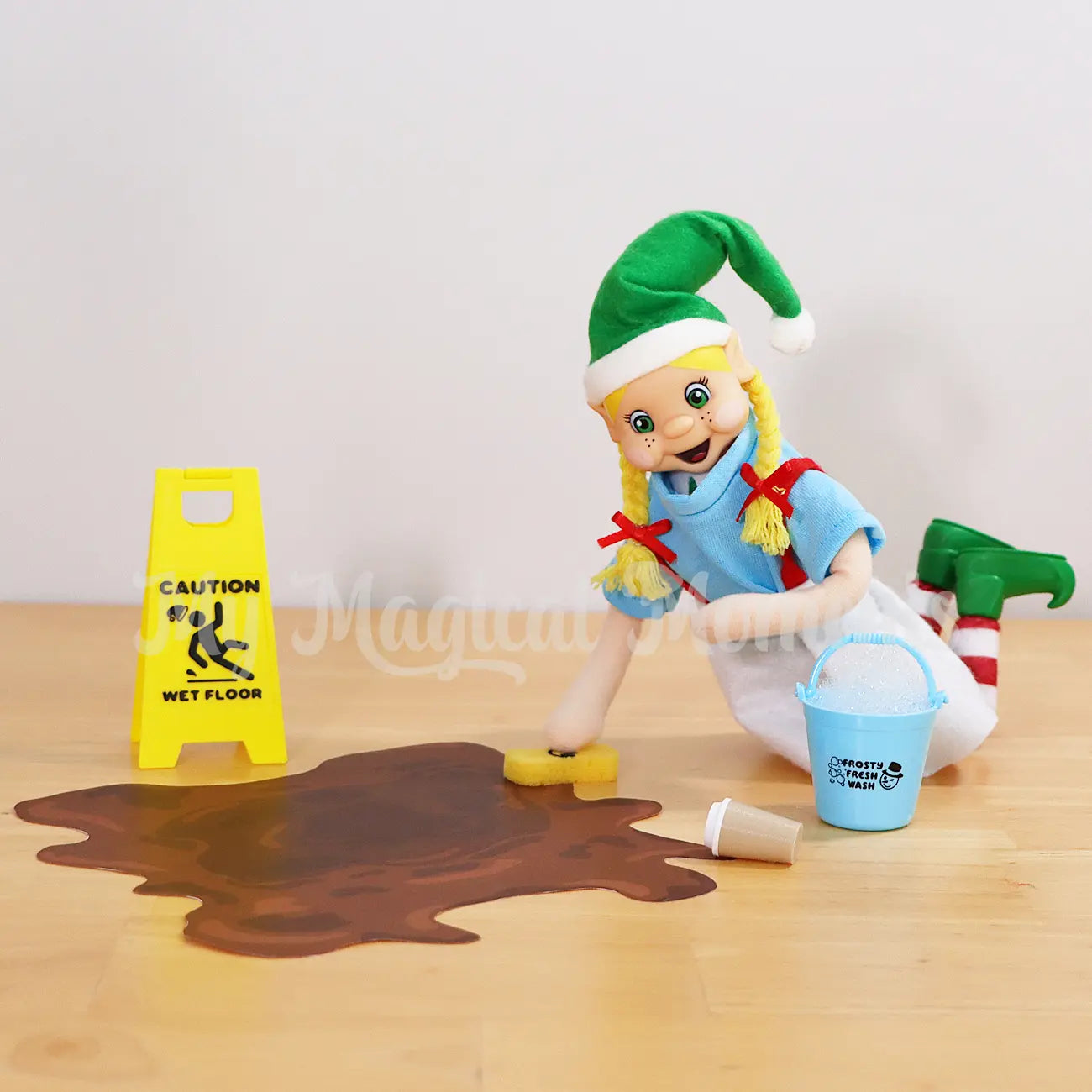 Blonde Hair Bendable Elf wearing a blue shirt, cleaning up coffee spill with a bucket and sponge, wet floor sign and mud printable