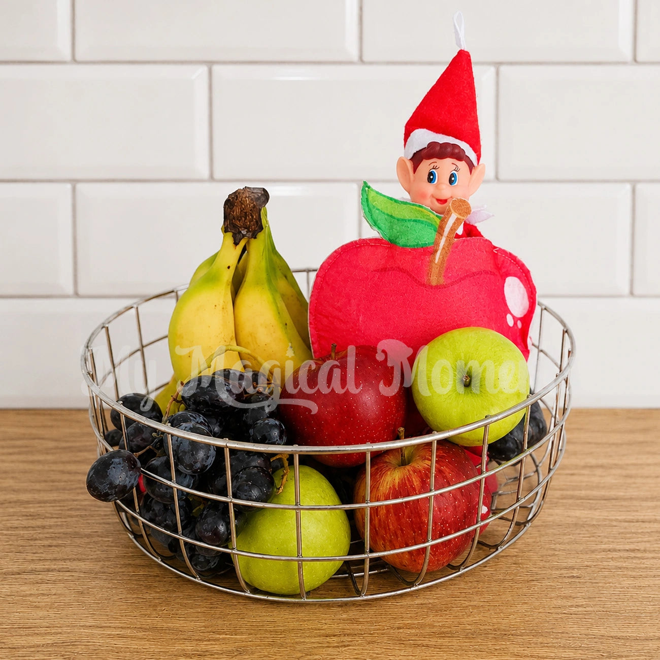 elf dressed as an apple in a fruit bowl