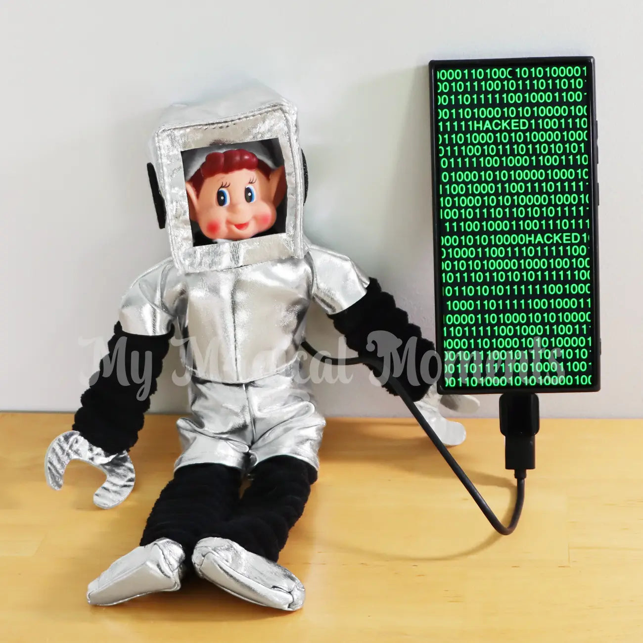 Elves behavin Badly elf wearing a robot costume hacking into a mobile phone