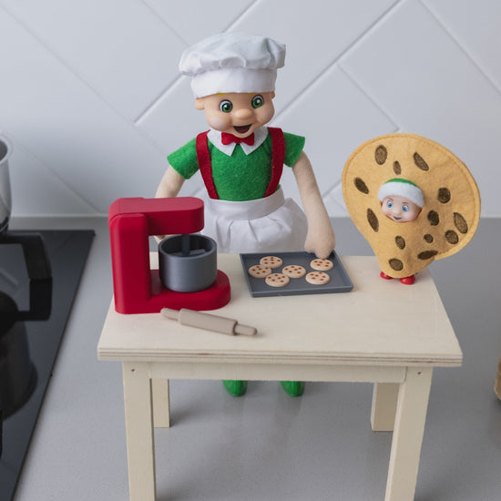 elf baking in the kitchen with a mini mixer