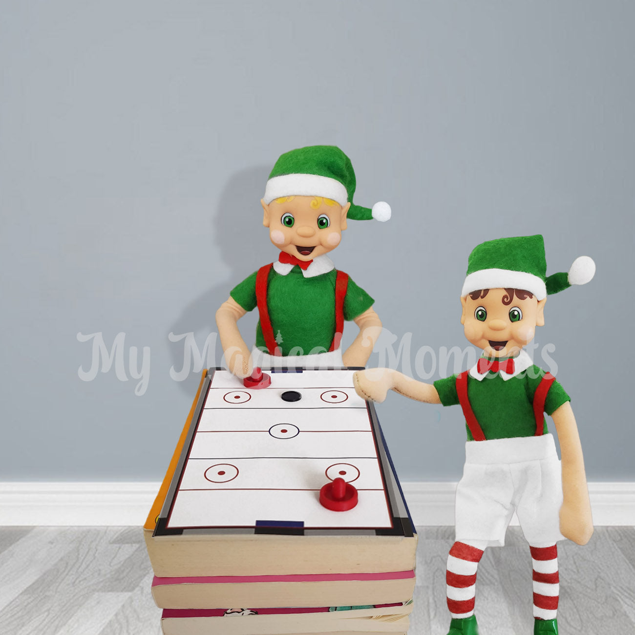 Elves playing air hockey on top of books