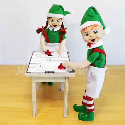 Elves playing with a mini air hockey scene 