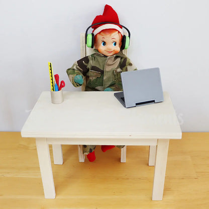 Elf wearing headphones dressed in an army uniform working on a laptop on  a mini table