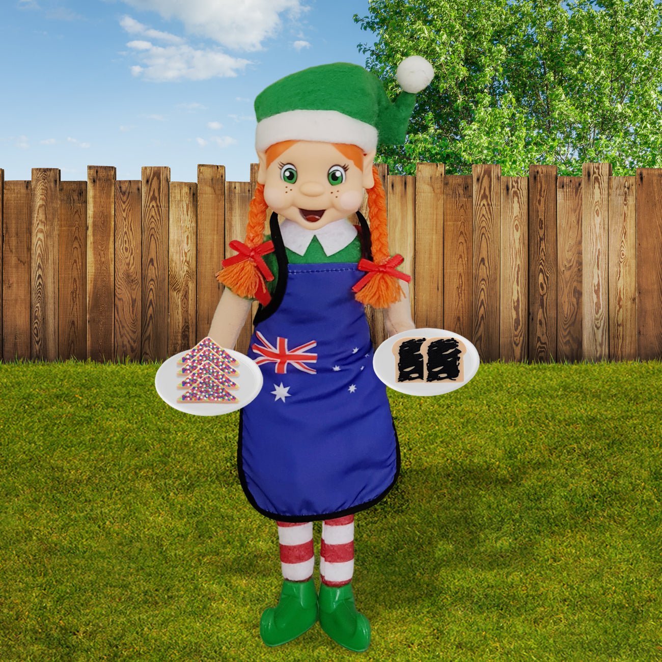 Girl elf wearing an aussie apron holding miniature fairy bread and vegemite