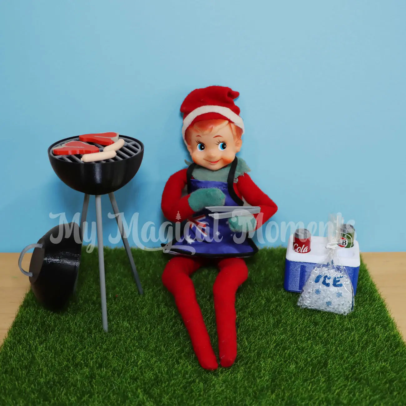 Elf playing with a elf sized bbq and esky prop