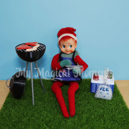 Elf playing with a elf sized bbq and esky prop