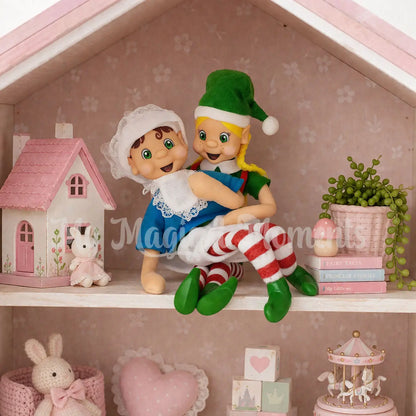 Elf Mum looking after elf dressed in a baby costume on a dollhouse shelf