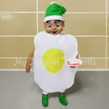 Elf holding bacon and eggs dressed as an egg