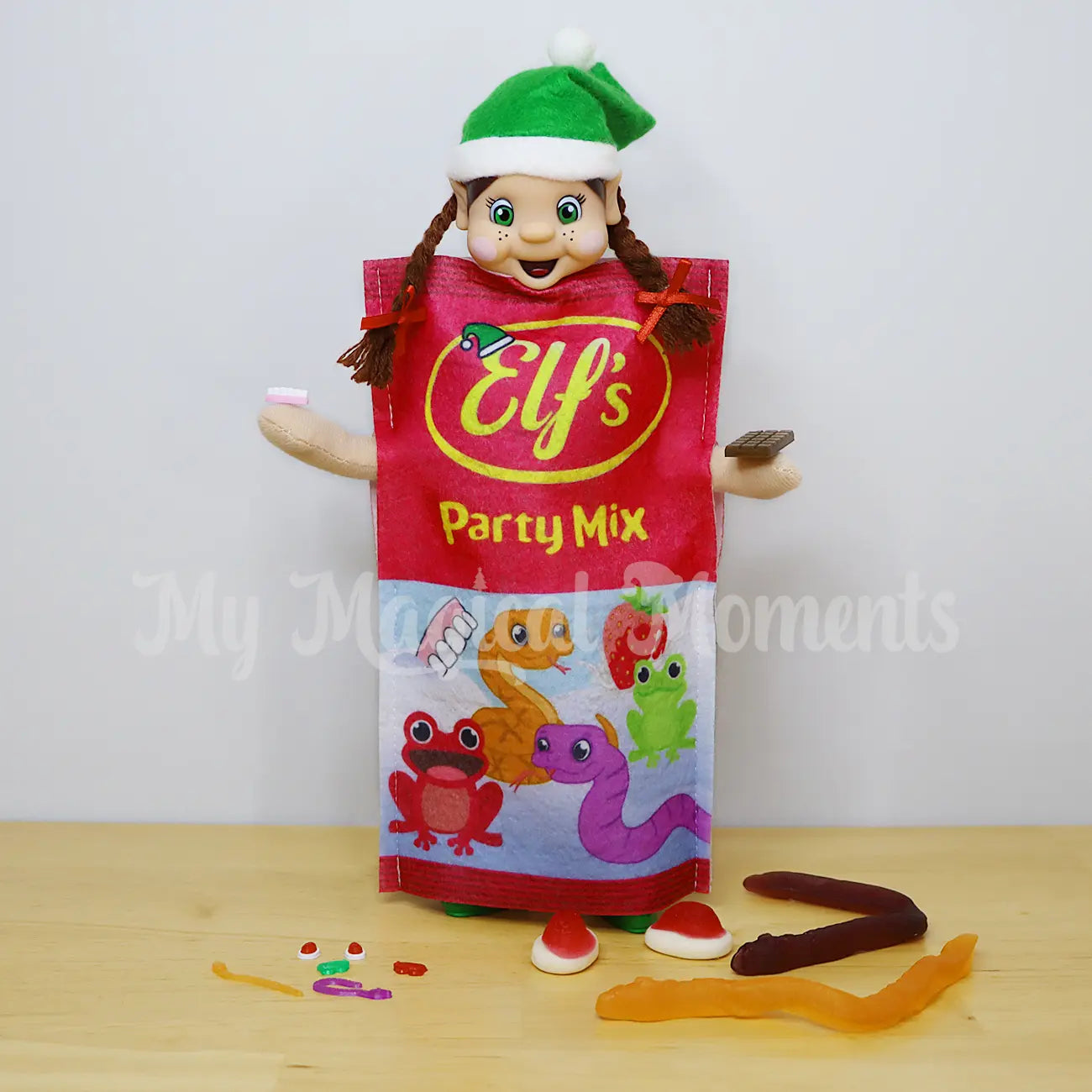 Elf wearing a bag of lollies costume with miniature elf sized lollies and chocolate