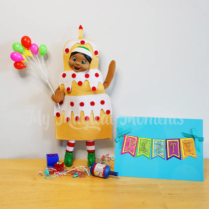 elf dressed in a cake costume celebrating a birthday with mini balloon and presents