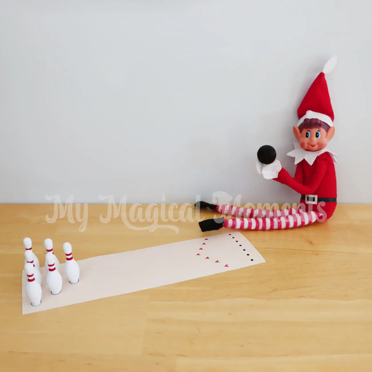 Elf bowling with a set of miniature bowling pins