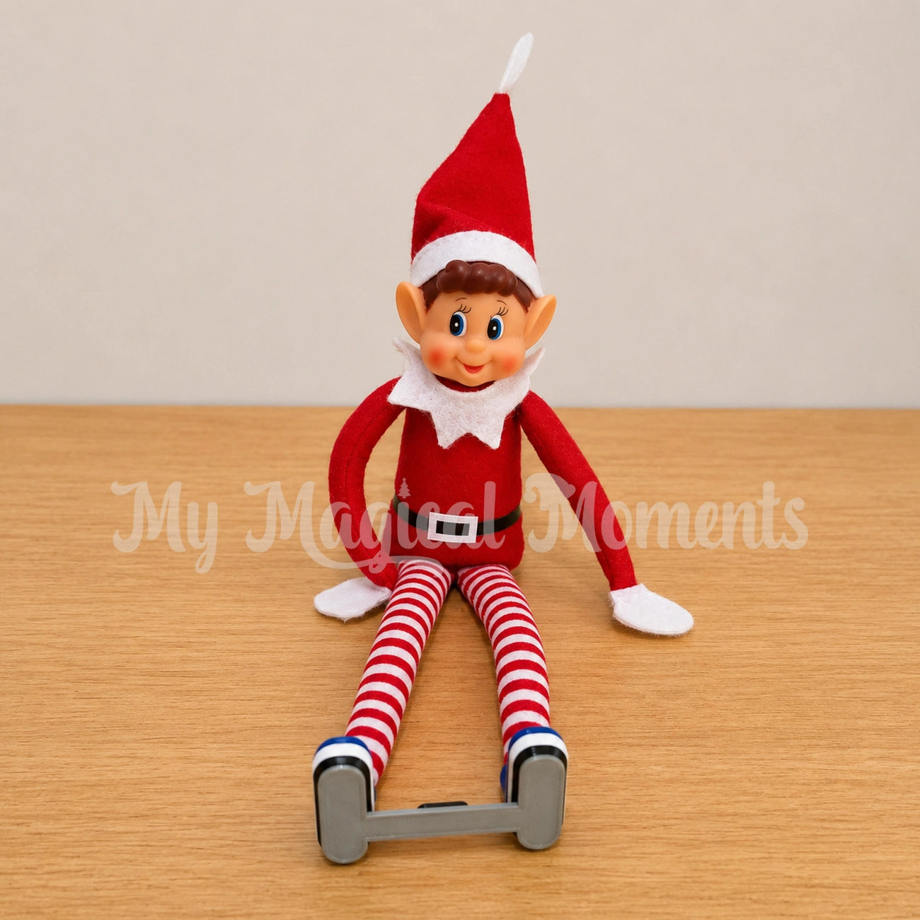 Boy Elf sitting down wearing Blue Ponseti Boots