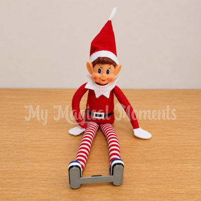 Boy Elf sitting down wearing Blue Ponseti Boots