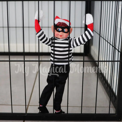 elves behavin badly trapped in a cage dressed in a burglar costume