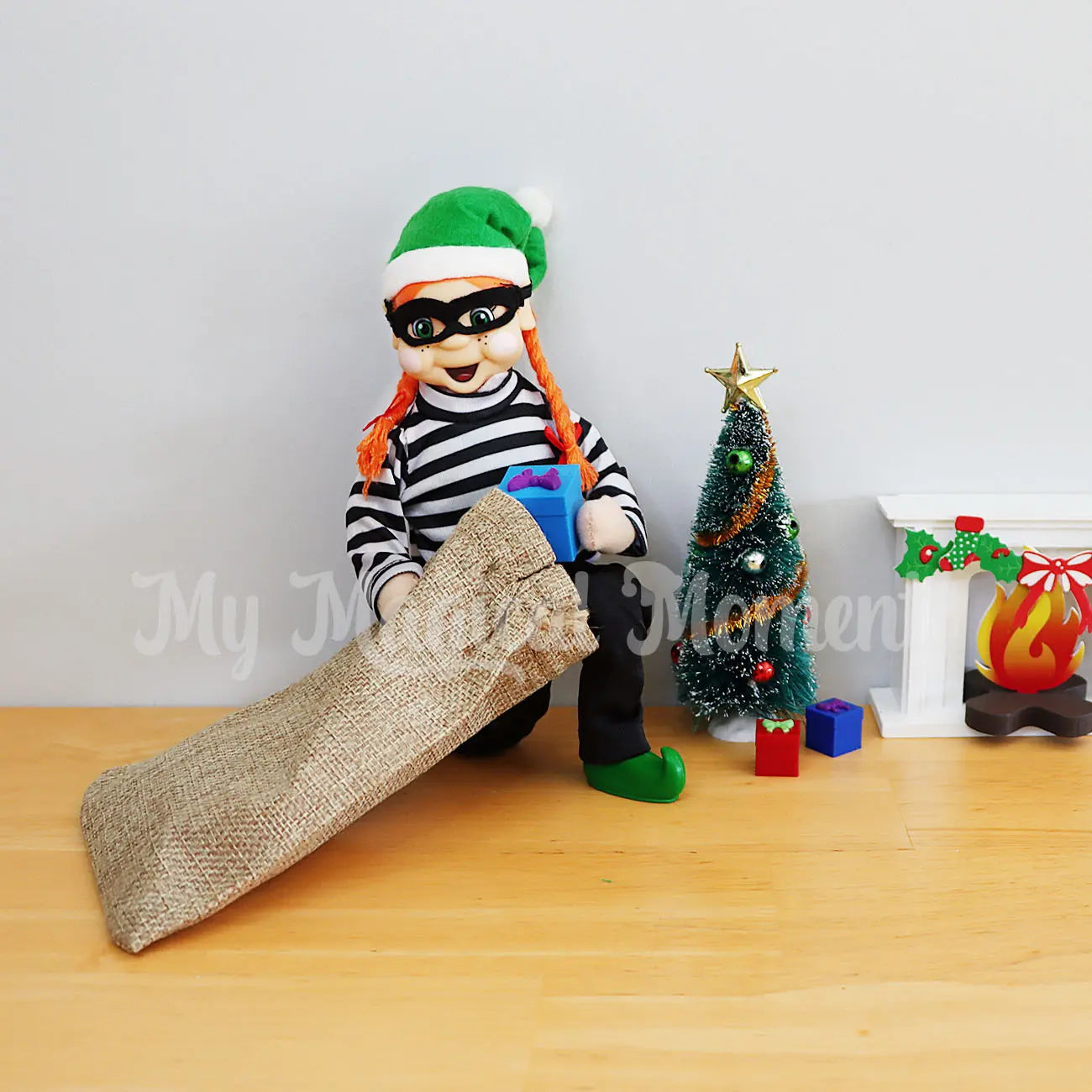 Burglar Stealing presents from under the Christmas tree and fireplace