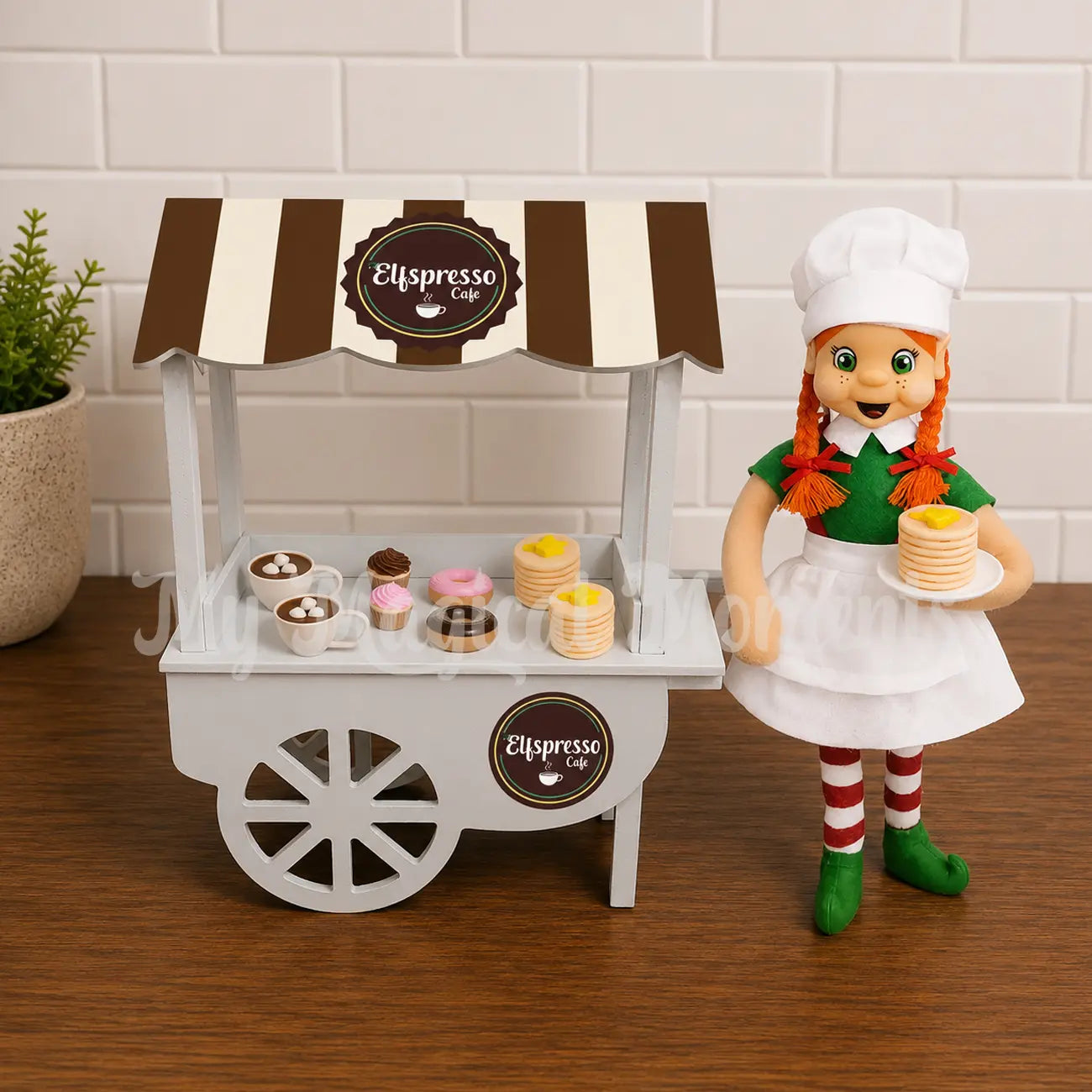 Elf selling pancakes, hot cocoa , donuts and cupcakes at a cafe