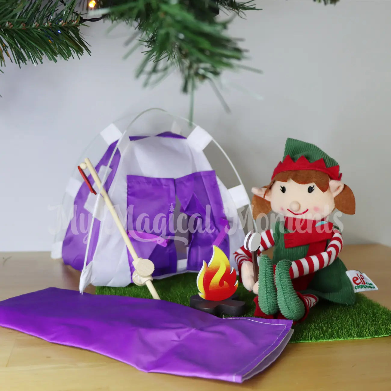 elf camping with a purple sleeping bag and miniature tent