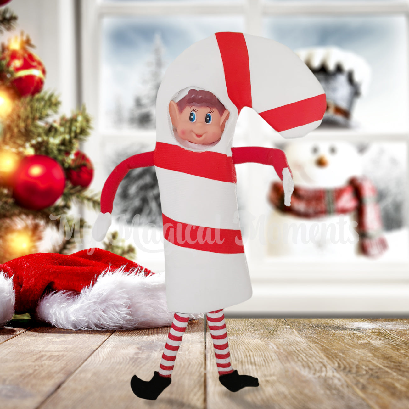 Elves Behavin Badly Dressed as a Candy Cane by A Christmas tree