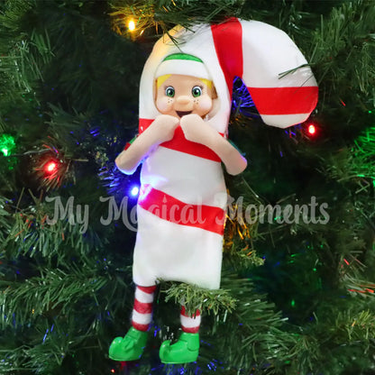 Elf wearing a candy cane costume in a Christmas Tree