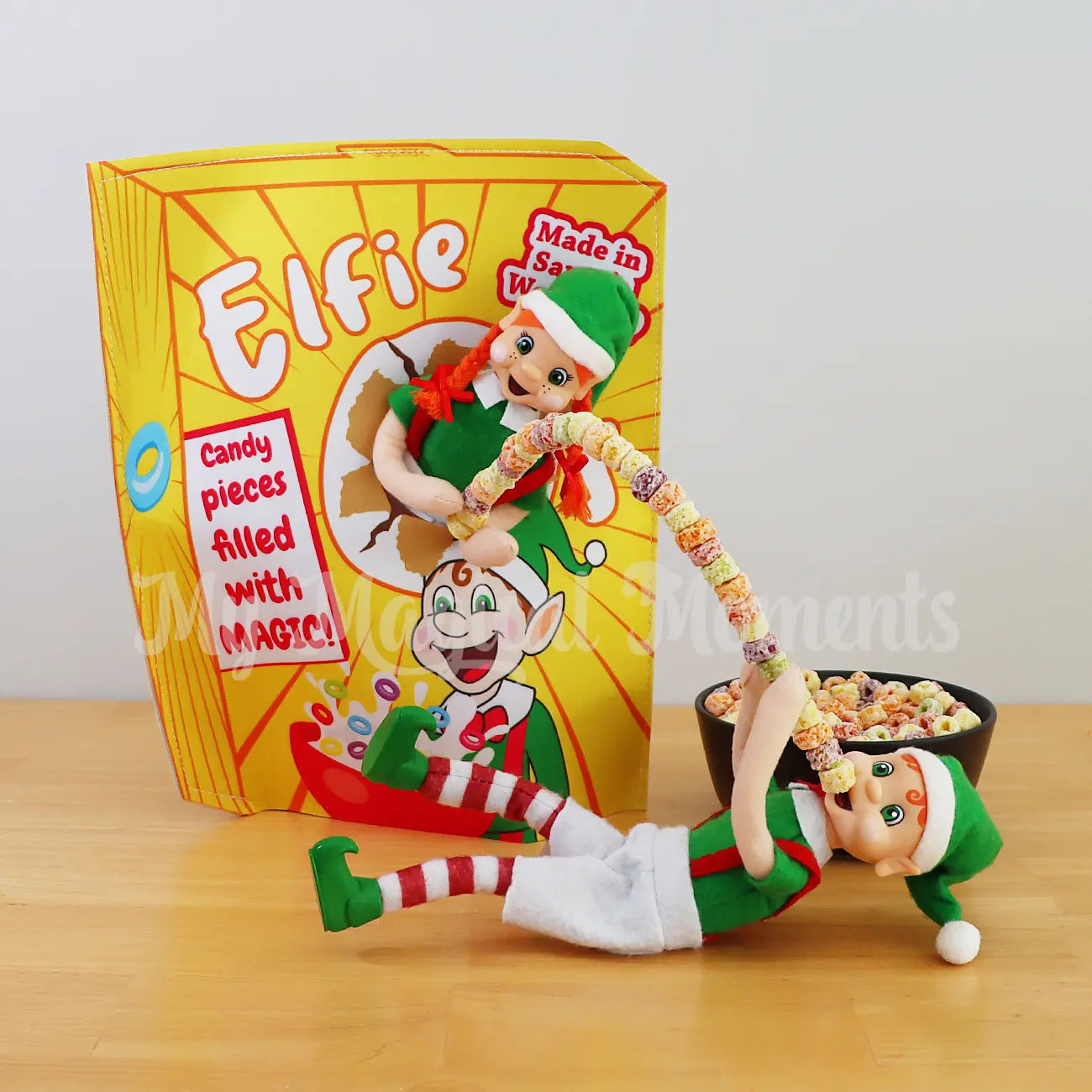 Elves using magic to eat cereal one wearing a cereal box costume
