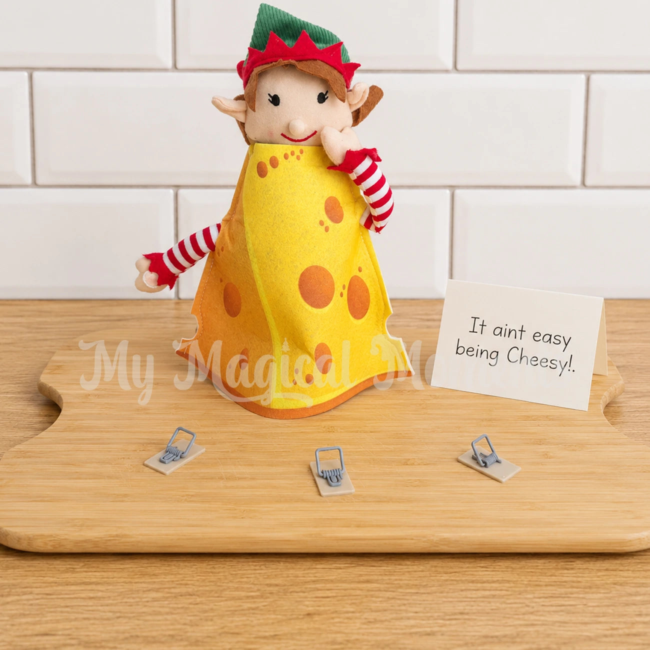 Elf wearing a cheese costume with mouse traps on a chopping board, there is a sign saying it aint easy being cheesy