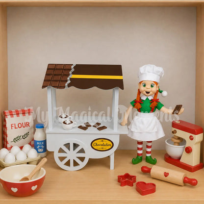 Elf dressed as a chef selling mini chocolate bars from their chocolatier shop