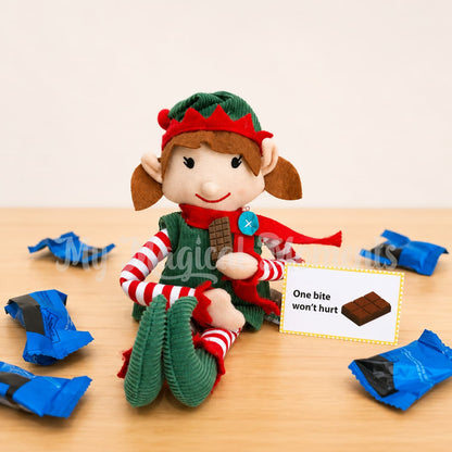 elf eating a mini chocolate bar. with empty chocolate wrappers around