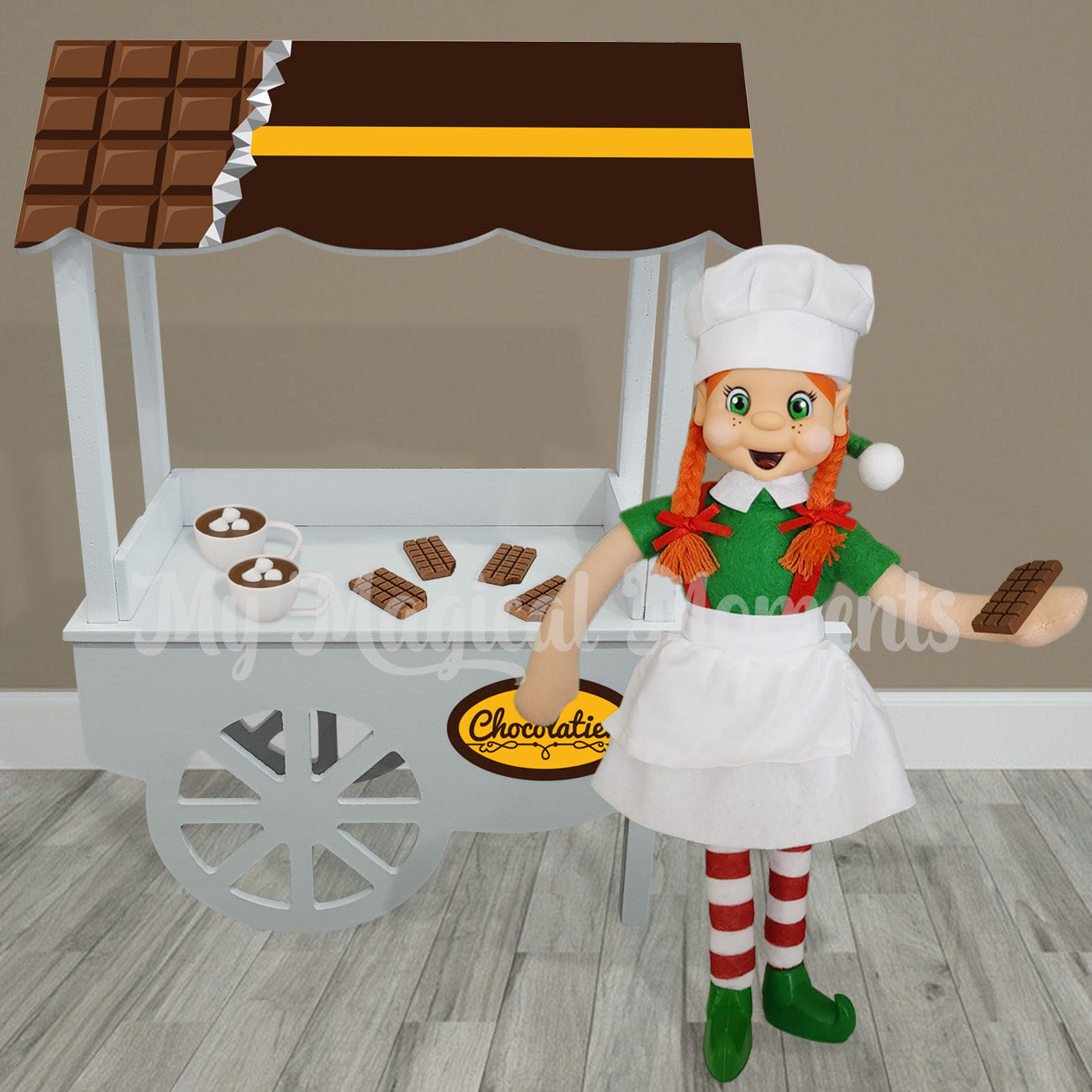 Elf dressed as a chef selling mini chocolate bars from their chocolatier shop