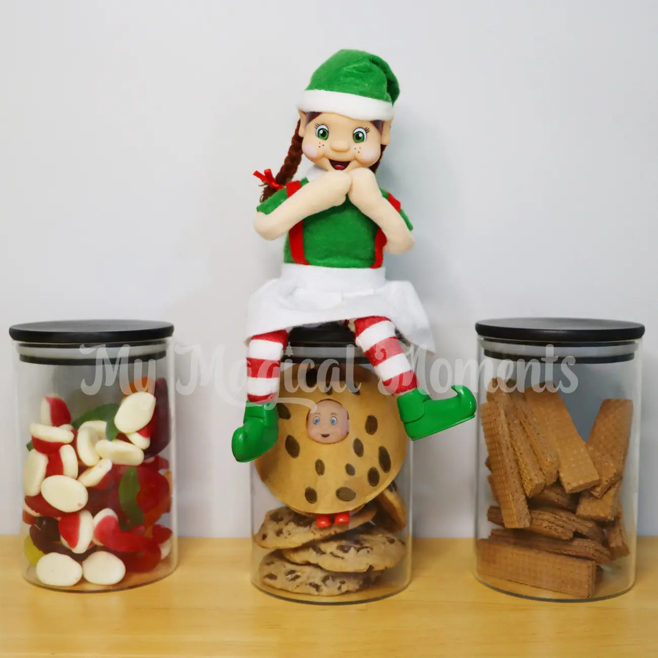 Baby Elf wearing a cookie costume in a cookie jar