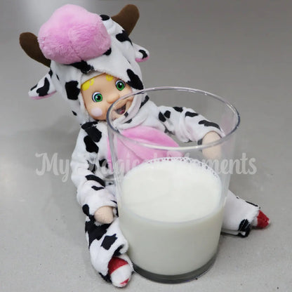 Elf dressed in a cow costume with a glass of milk