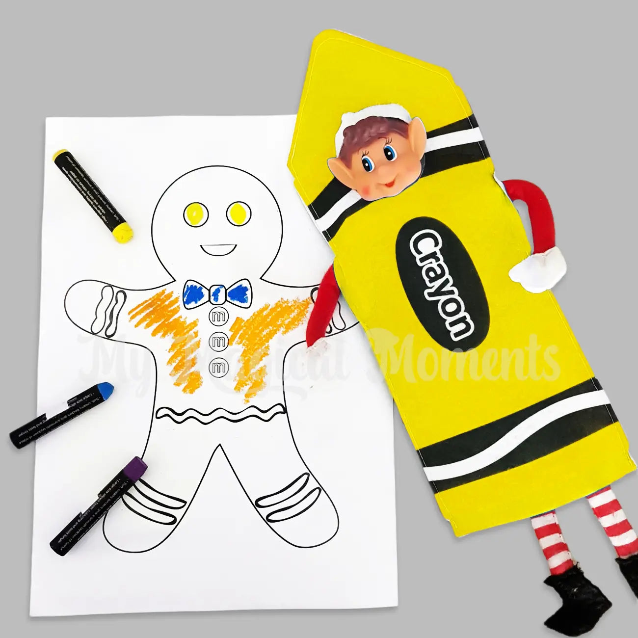 Elves behavin badly elf wearing a yellow crayon costume, colouring a gingerbread in