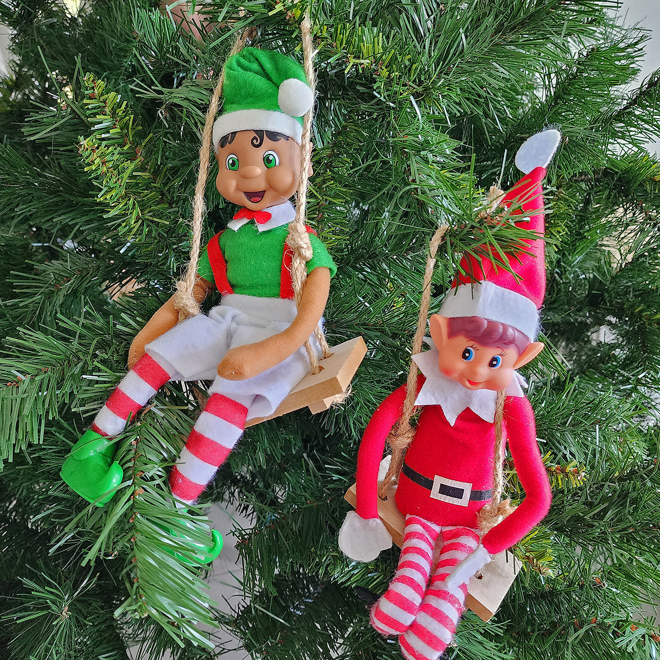 elves swinging in the christmas tree