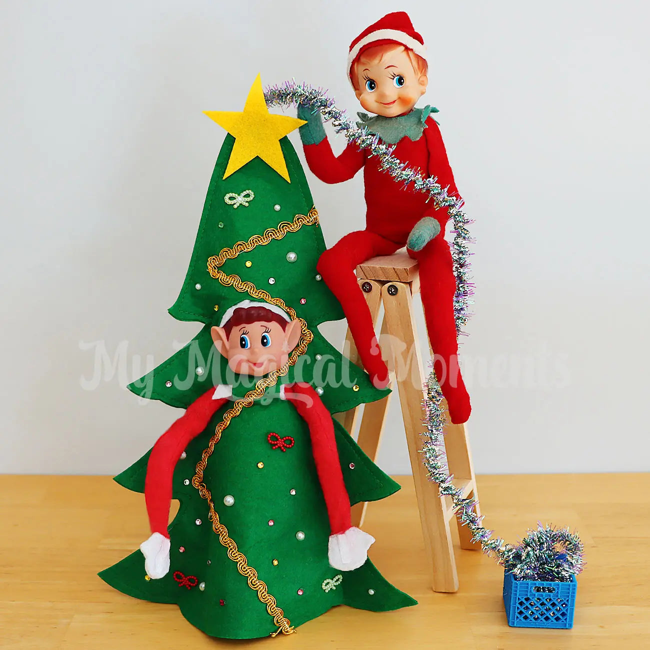 Elf wearing a Christmas Tree Costume, Sitting on a ladder and a crate of decorations