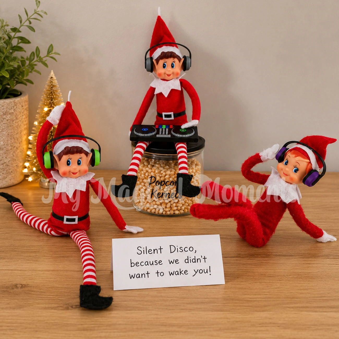 Elves having a silent Disco using a mini DJ turntable and elves wearing headphones