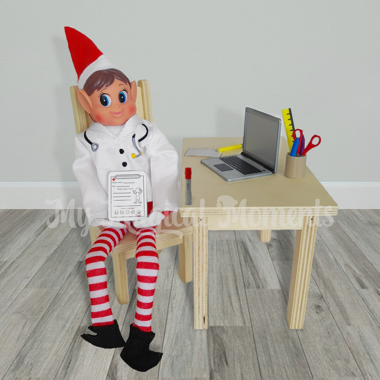Elves behavin badly dressed as a doctor at a wooden table and using his little laptop and Humira pen