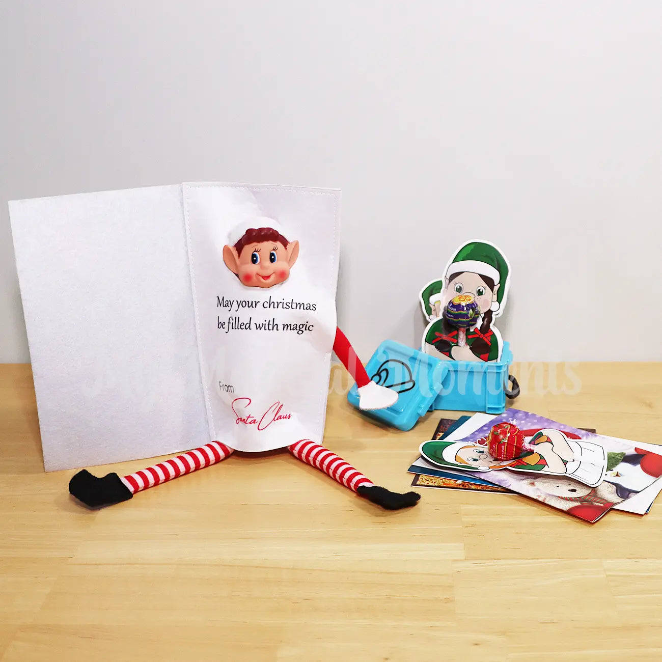 Elf Wearing a Card costume with Christmas gifts, lollipop elf holders in a container