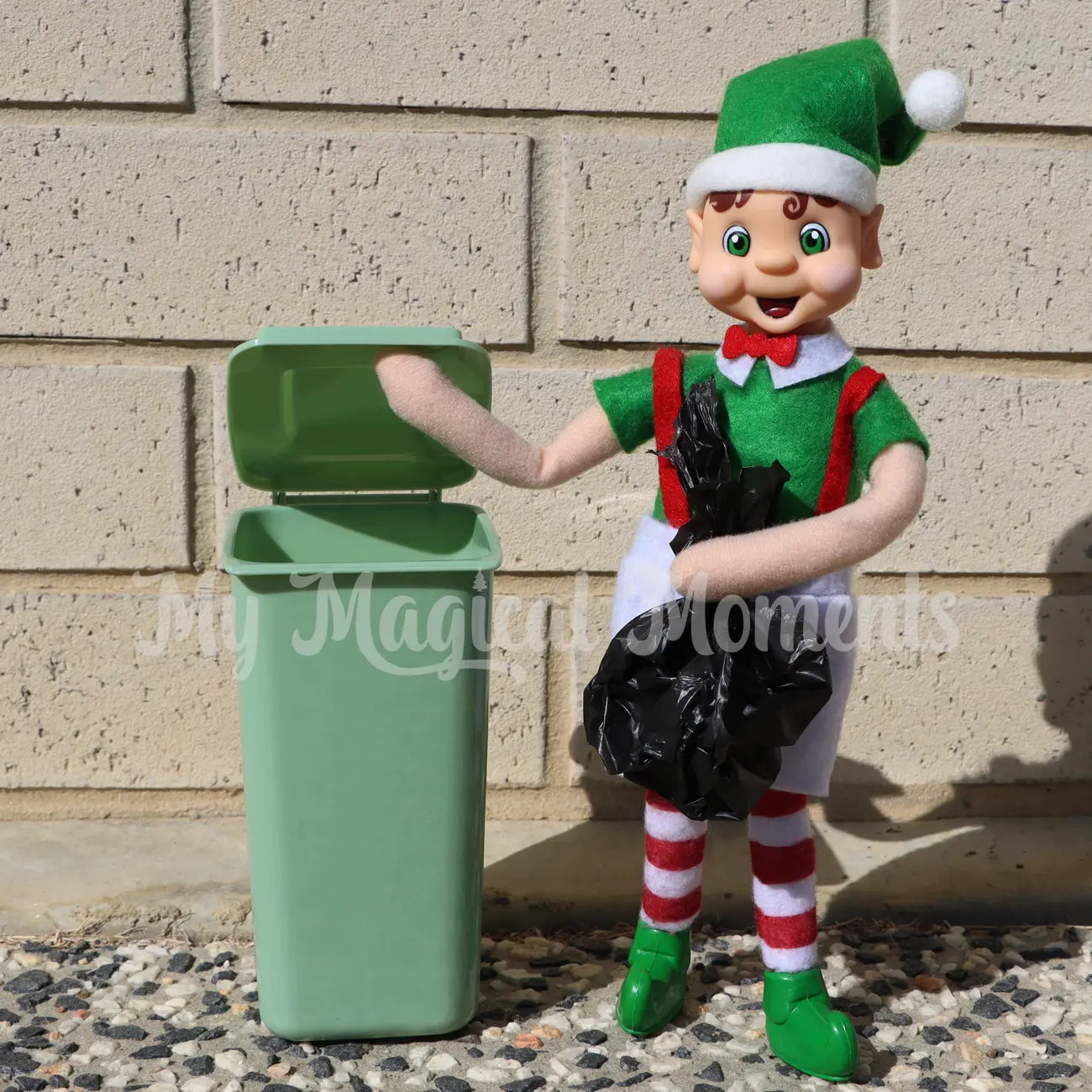 elf putting mini rubbish in the miniature elf prop bin