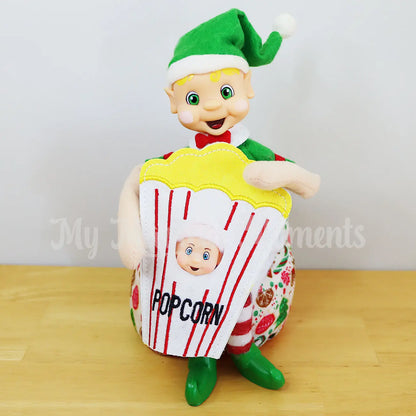 Blonde Hair Bendable elf holding an elf baby dressed as popcorn