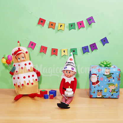 Elves behavin badly wearing a party hat printable, with elf shelf wearing a cake costume holding mini balloons. A Vanilla elf sized cake and presents With a happy birthday banner