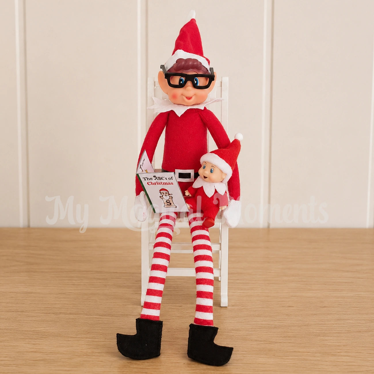 an elves behavin badly elf wearing glasses reading a story to an elf baby
