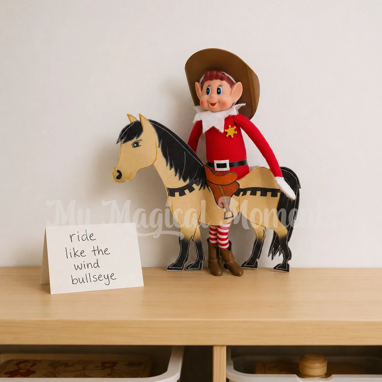 Elf wearing a cowboy hat, boots and a sheriff badge, wearing a horse costume.  There is a sign that says ride like the wind bullseye