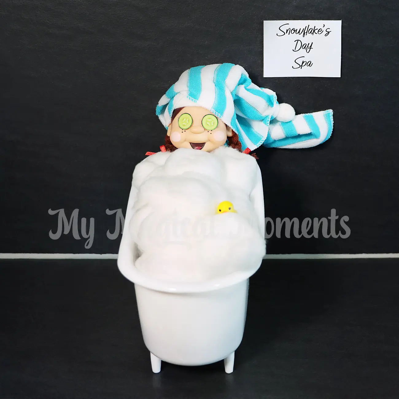 Elf enjoying a relaxing day spa with cucumber eyes, rubber ducky, towel on head and in a bath