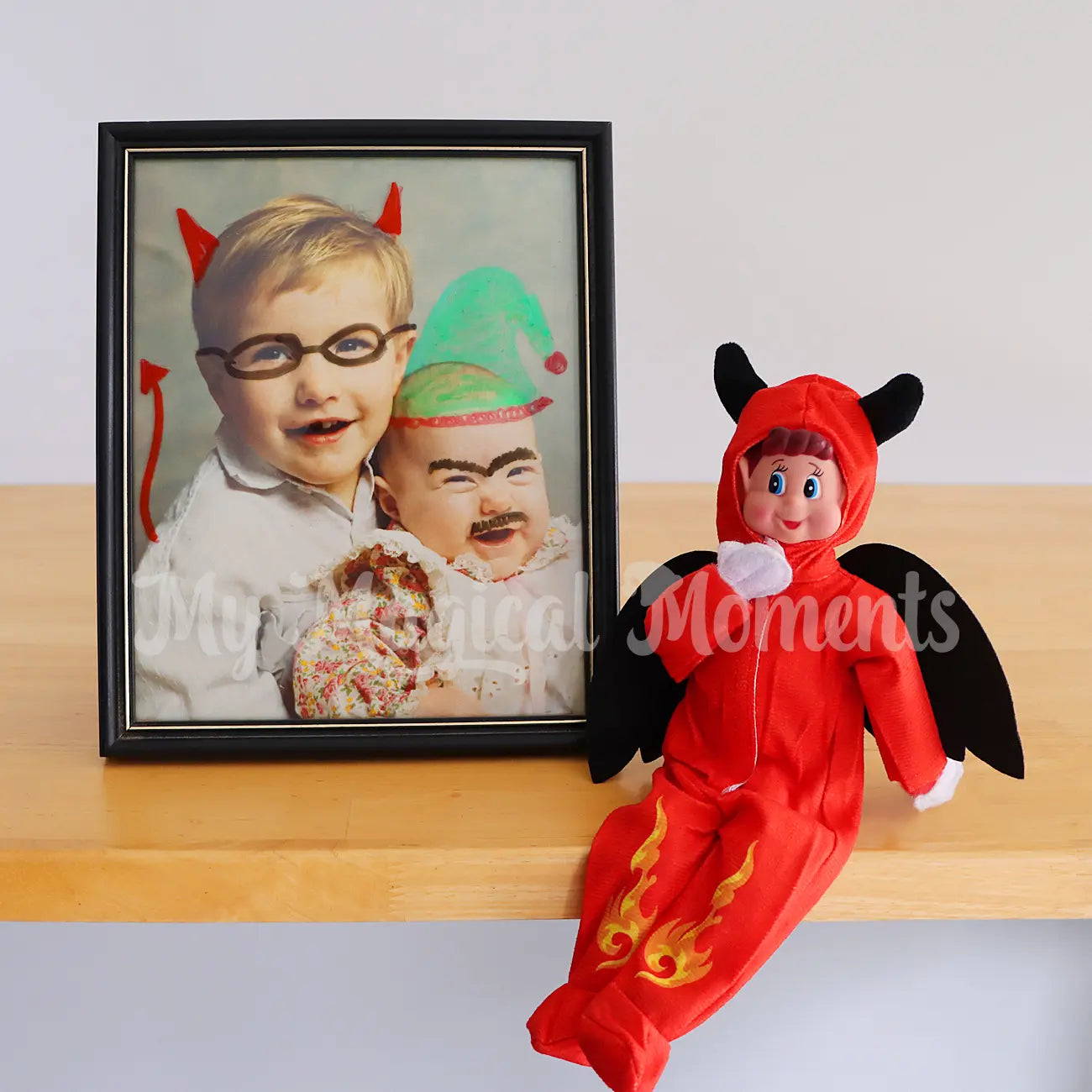 elf wearing a devil costume painting on family photos