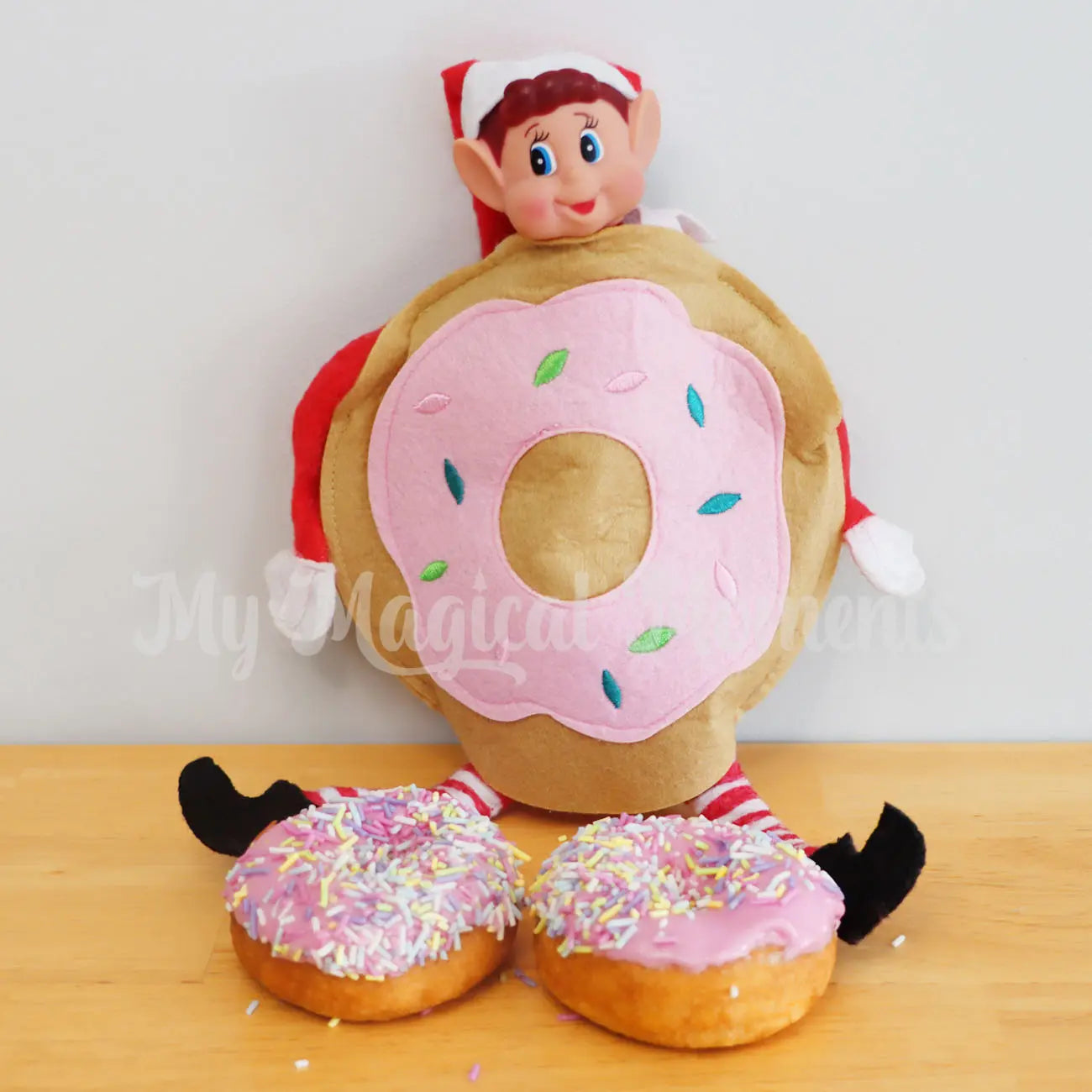 Elf wearing a donut costume with donuts in the kitchen