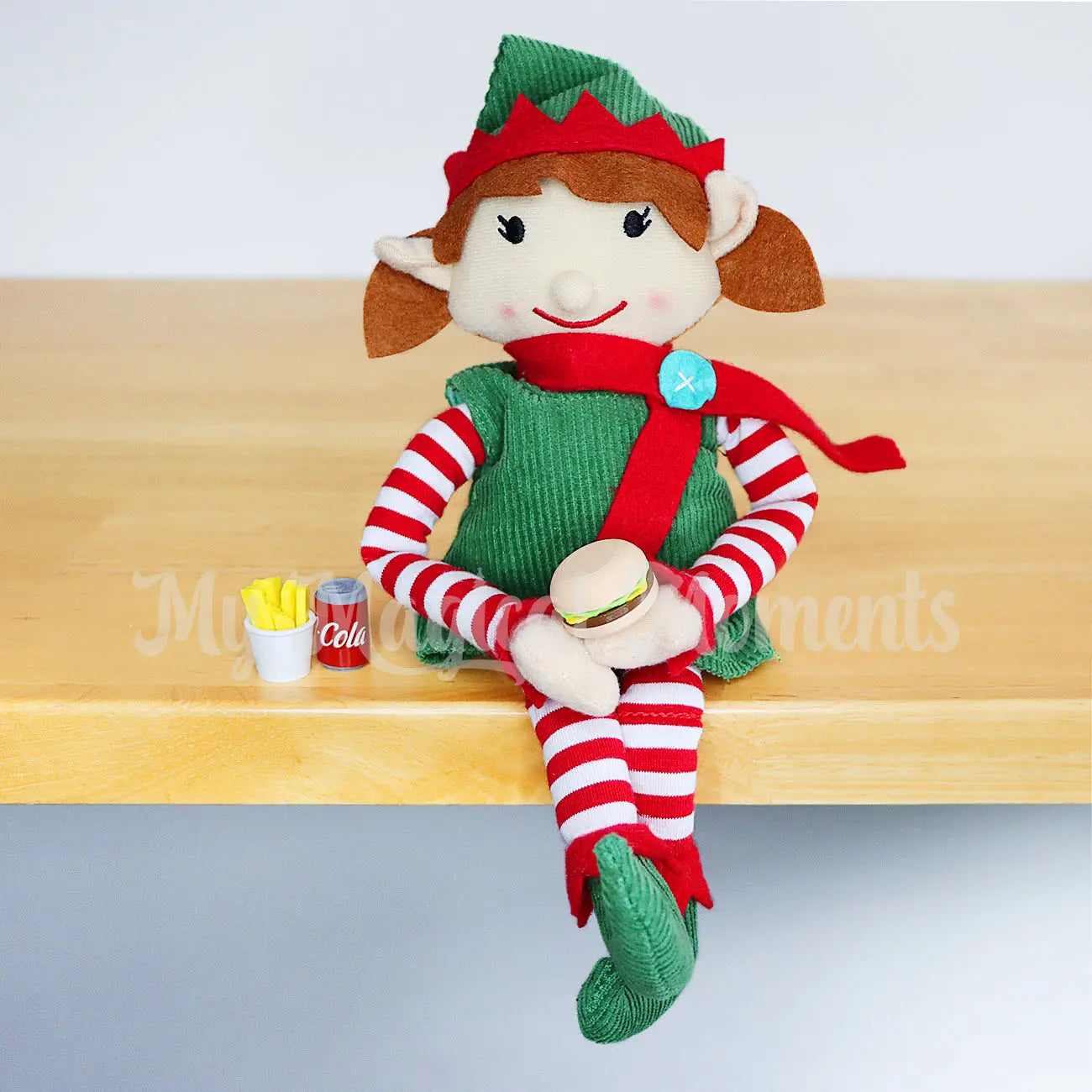 Elf eating a  mini burger with fries and cola