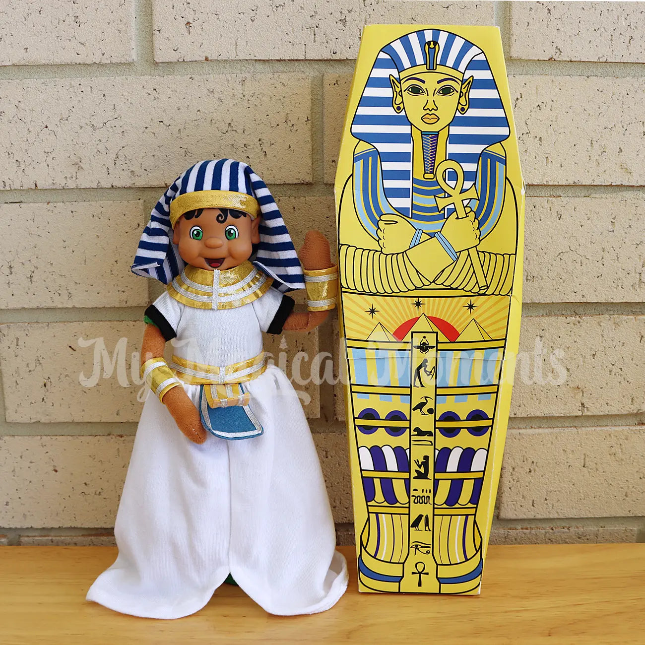 Elf wearing a pharaoh costume with a sarcophagus 