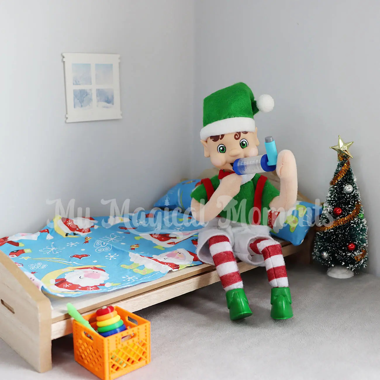 My Elf Friends sitting on a mini bed using a mini elf asthma puffer