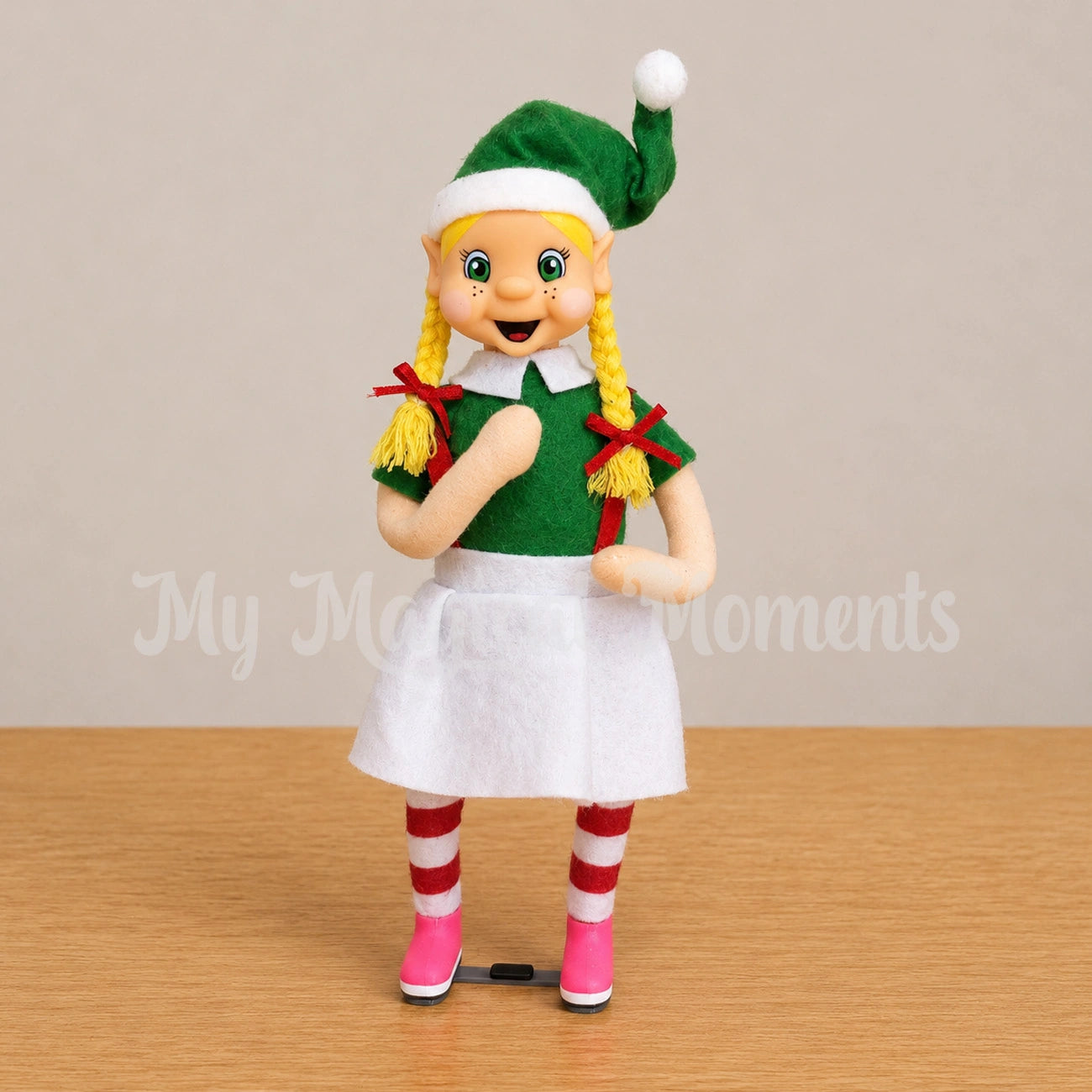 A Blonde Hair Girl elf wearing pink Ponseti Boots